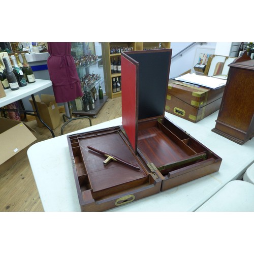 72 - A Georgian mahogany writing slope, with secret drawer and brass campaign handles, 44 by 29 by 13.5cm... 