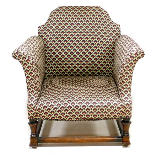 271 - An Edwardian armchair, with Queen Anne shaped back, scroll arms, upholstered in a leaf patterned cot... 