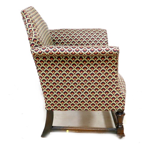 271 - An Edwardian armchair, with Queen Anne shaped back, scroll arms, upholstered in a leaf patterned cot... 