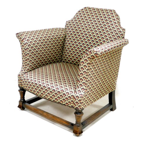 271 - An Edwardian armchair, with Queen Anne shaped back, scroll arms, upholstered in a leaf patterned cot... 