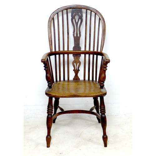 268 - An early 19th century oak and elm Windsor chair, with pierced splat and spindle back, raised on turn... 