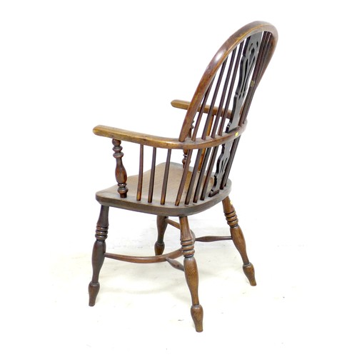 268 - An early 19th century oak and elm Windsor chair, with pierced splat and spindle back, raised on turn... 