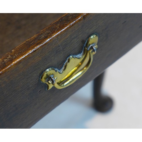 263 - An early Georgian oak lowboy, with single drawer, brass swan neck handle, raised on turned tapering ... 