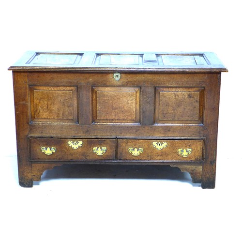 275 - An 18th century oak mule chest, with three carved panels to the front, over two drawers, raised on s... 