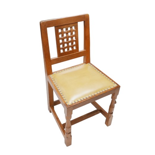 282 - Robert 'Mouseman' Thompson of Kilburn (British, 1876-1955): a set of eight oak dining chairs, lattic... 