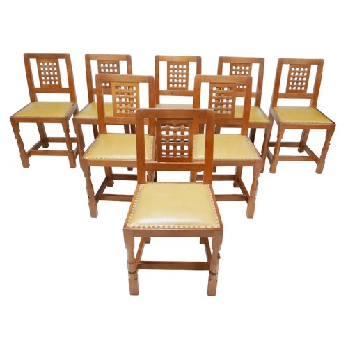 Robert 'Mouseman' Thompson of Kilburn (British, 1876-1955): a set of eight oak dining chairs, lattice back design, the seats upholstered, raised on carved octagonal front legs joined by stretchers, each with a carved mouse signature to front leg. (8)