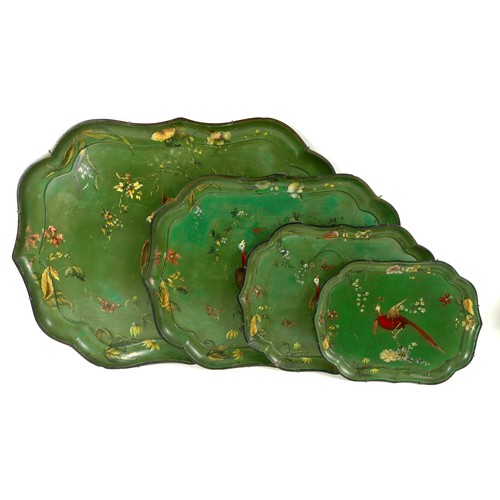 A graduating set of four Regency tole painted papier mache trays, circa 1830, each with scalloped edge, painted with an Asiatic pheasant on a branch surrounded by flowers and butterflies, against a green background, stamped 'Jennens & Bettridge, London', largest 79.5 by 59.5cm, smallest 38.5 by 29cm. (4)