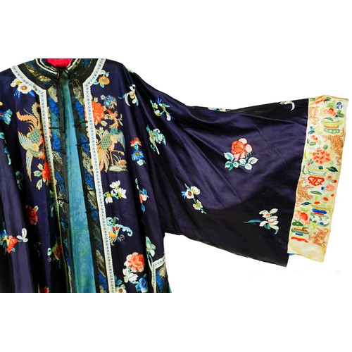 133 - An early 20th century Japanese embroidered silk kimono, decorated with exotic flowers and birds upon... 