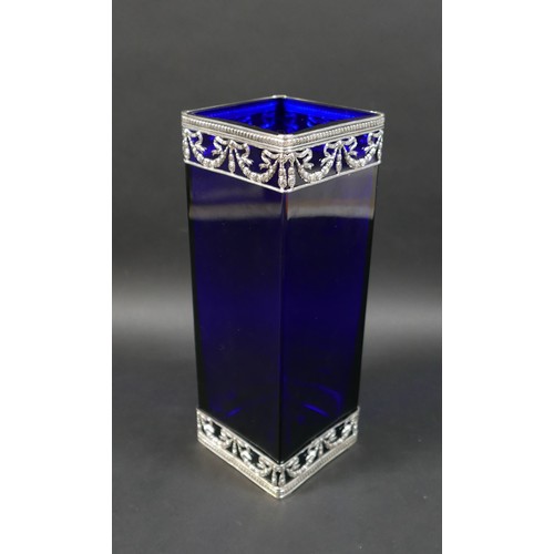 83 - Two silver and white metal mounted glass vases, comprising a blue glass rectangular form vase with p... 