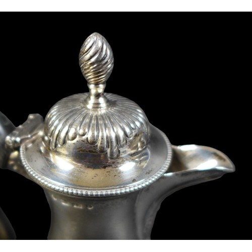 73 - A Victorian silver coffee pot, of baluster form with reeded decoration, ebonised handle, on a circul... 