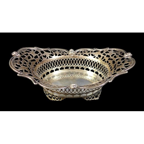 75 - A group of silver items, including an Edwardian silver bowl, of boat form with pierced sides and rim... 