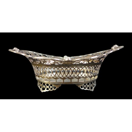 75 - A group of silver items, including an Edwardian silver bowl, of boat form with pierced sides and rim... 