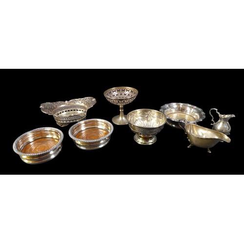 75 - A group of silver items, including an Edwardian silver bowl, of boat form with pierced sides and rim... 