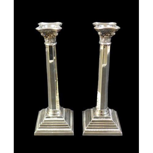 88 - A pair of silver candlesticks, the octagonal section columns with Corinthian capitals and removable ... 