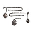 An Edwardian silver double Albert chain, attached with two T-bars and three fobs, one fob inscribed ... 