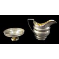 Two pieces of George III and later silver, comprising A George III milk jug with parcel gilt interio... 