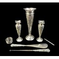 A group of silver, comprising  three spill vases with weighted bases, a swizzle stick, a shoe horn a... 