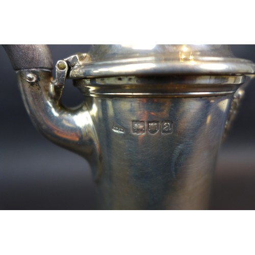 86 - A Victorian silver coffee pot, with lobed decoration to lid and base, an ebonised handle, Daniel & J... 