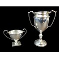 Two George V and later silver twin handled trophies, both without inscriptions, comprising a George ... 