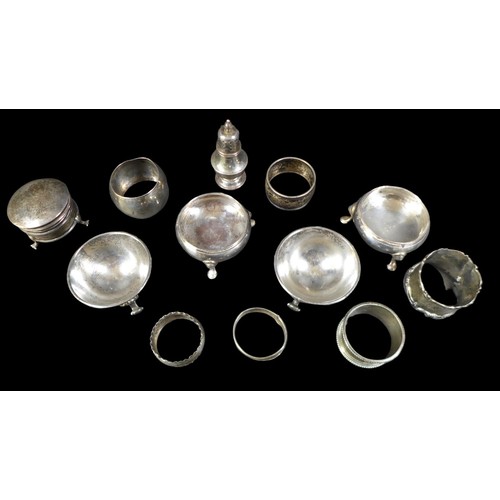 79 - A group of silver items, comprising two pairs of cauldron salts, a lidded pot, small pepperette, and... 