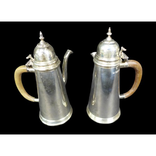 105 - Two Elizabeth II silver coffee and hot water pots, of tapering form with knopped finials to the hing... 