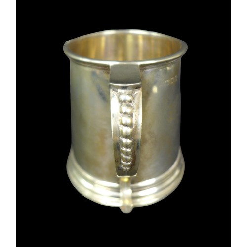 70 - An Elizabeth II silver tankard, of tapering form, the S scroll handle with bead decoration, probably... 