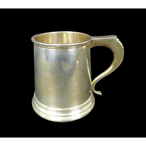 70 - An Elizabeth II silver tankard, of tapering form, the S scroll handle with bead decoration, probably... 