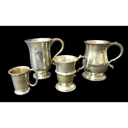 96 - A group of four silver tankards, largest in Georgian style with heart shaped terminal to handle, 14c... 