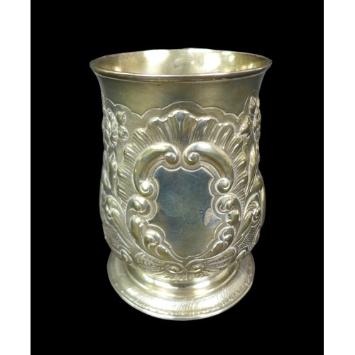 68 - A George III silver tankard, with later repousse decoration, of baluster form with double C scroll h... 