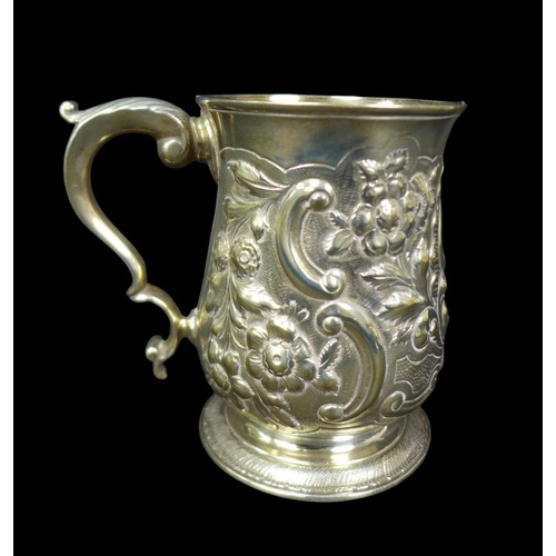 68 - A George III silver tankard, with later repousse decoration, of baluster form with double C scroll h... 