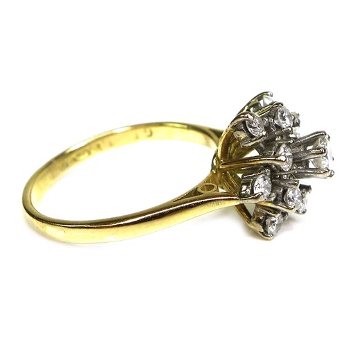 320 - An 18ct gold and diamond starburst cluster ring, set with brilliant cut diamonds, the central larges... 