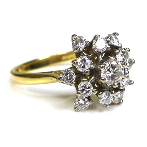 320 - An 18ct gold and diamond starburst cluster ring, set with brilliant cut diamonds, the central larges... 