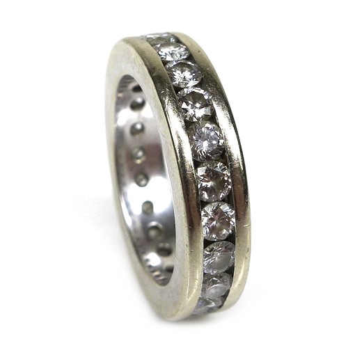 379 - A white gold and diamond eternity ring, each of the 23 brilliant cut stones 3mm diameter, a/f one mi... 