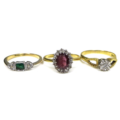 346 - A group of three 18ct gold rings, the first with an emerald and diamond chips set in a platinum face... 