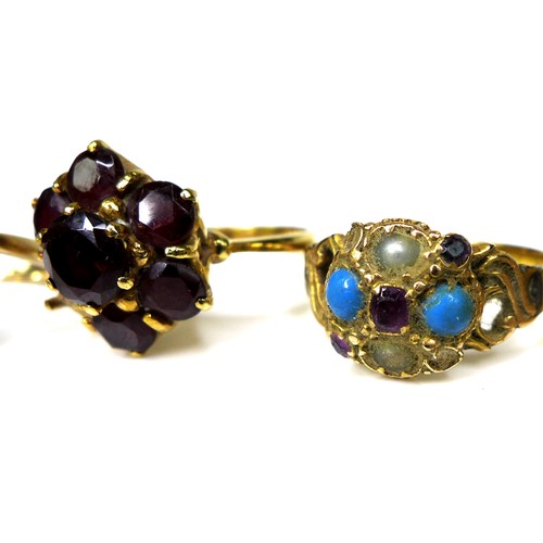 296 - A group of gold rings, comprising an 18ct gold and garnet flowerhead ring, a/f one stone missing, si... 