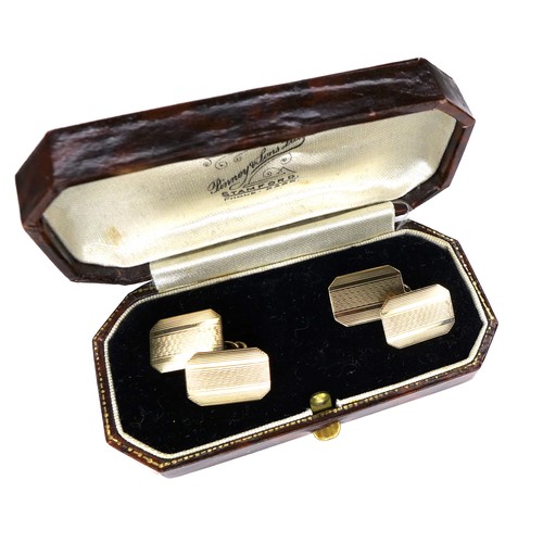 267 - A pair of vintage 9ct gold cufflinks, of canted rectangular form with engraved decoration, chain lin... 