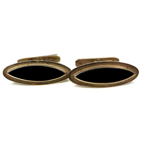 268 - A pair of vintage 9ct gold cufflinks, each of slender navette shape inset with a black stone, 'Swivl... 