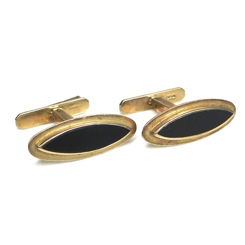 268 - A pair of vintage 9ct gold cufflinks, each of slender navette shape inset with a black stone, 'Swivl... 