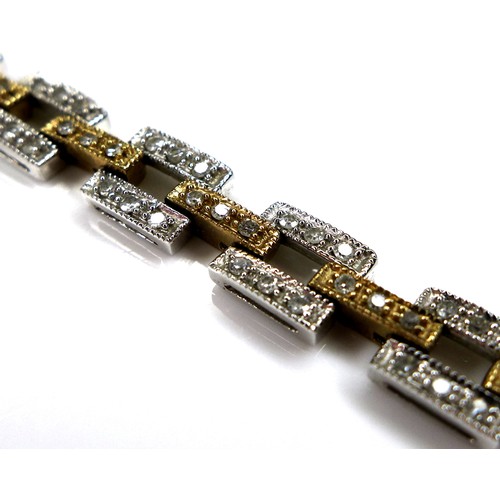 327 - A 9ct bi-colour gold and diamond set bracelet, rectangular white and yellow brick links, each set wi... 