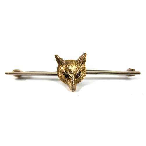 278 - A 9ct gold bar brooch, set with a fox's head mask with ruby eyes, A&W, Birmingham 1990, 51mm, 4.2g, ... 