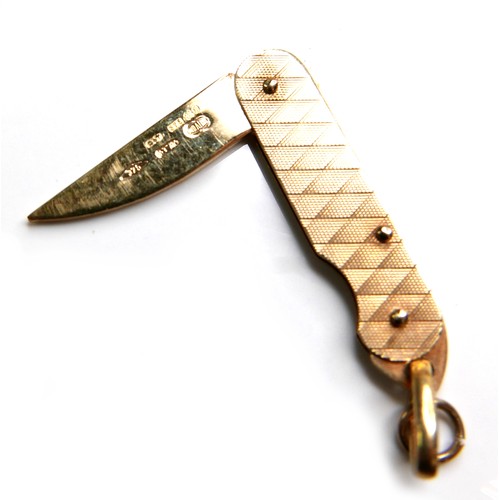 378 - A group of seventeen 9ct yellow gold charms, comprising folding pen knife, candelabra, razor blade, ... 