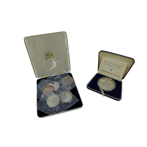 128 - A collection of first Moon landing coins, comprising a limited edition 