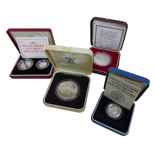 143 - A collection of British proof coins, including six cased sets of silver proof coins with certificate... 