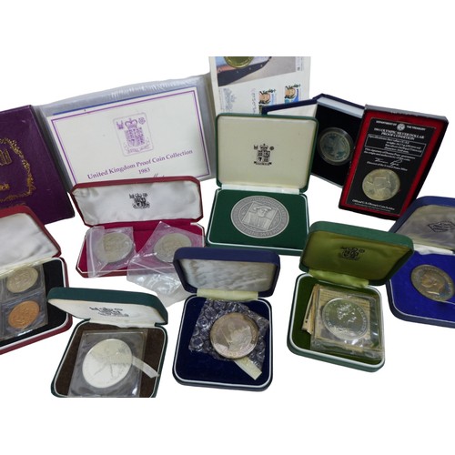 114 - A collection of assorted British and Commonwealth commemorative coins, including a '1973 First Offic... 