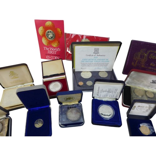 114 - A collection of assorted British and Commonwealth commemorative coins, including a '1973 First Offic... 