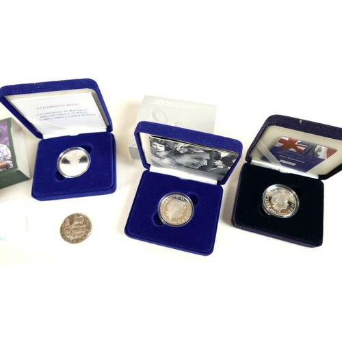 130 - A collection of ERII silver coins, comprising six Royal Mint silver proof crowns, including one pied... 