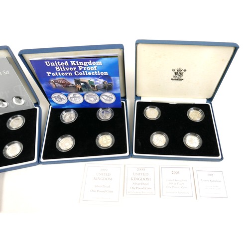 132 - A collection of ERII silver £1 coins, comprising four Royal Mint silver proof four-coin sets, 2004 p... 
