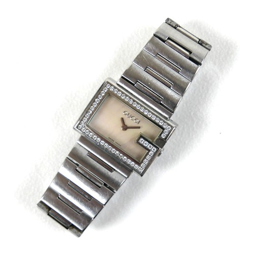 247 - A Gucci stainless steel lady's wristwatch, with diamond set G-shaped bezel, model 100L, serial 10344... 