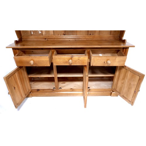 271 - A modern pine dresser, with plate rack over three drawers and three cupboards with turned knobs, 175... 