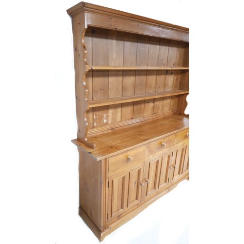 271 - A modern pine dresser, with plate rack over three drawers and three cupboards with turned knobs, 175... 